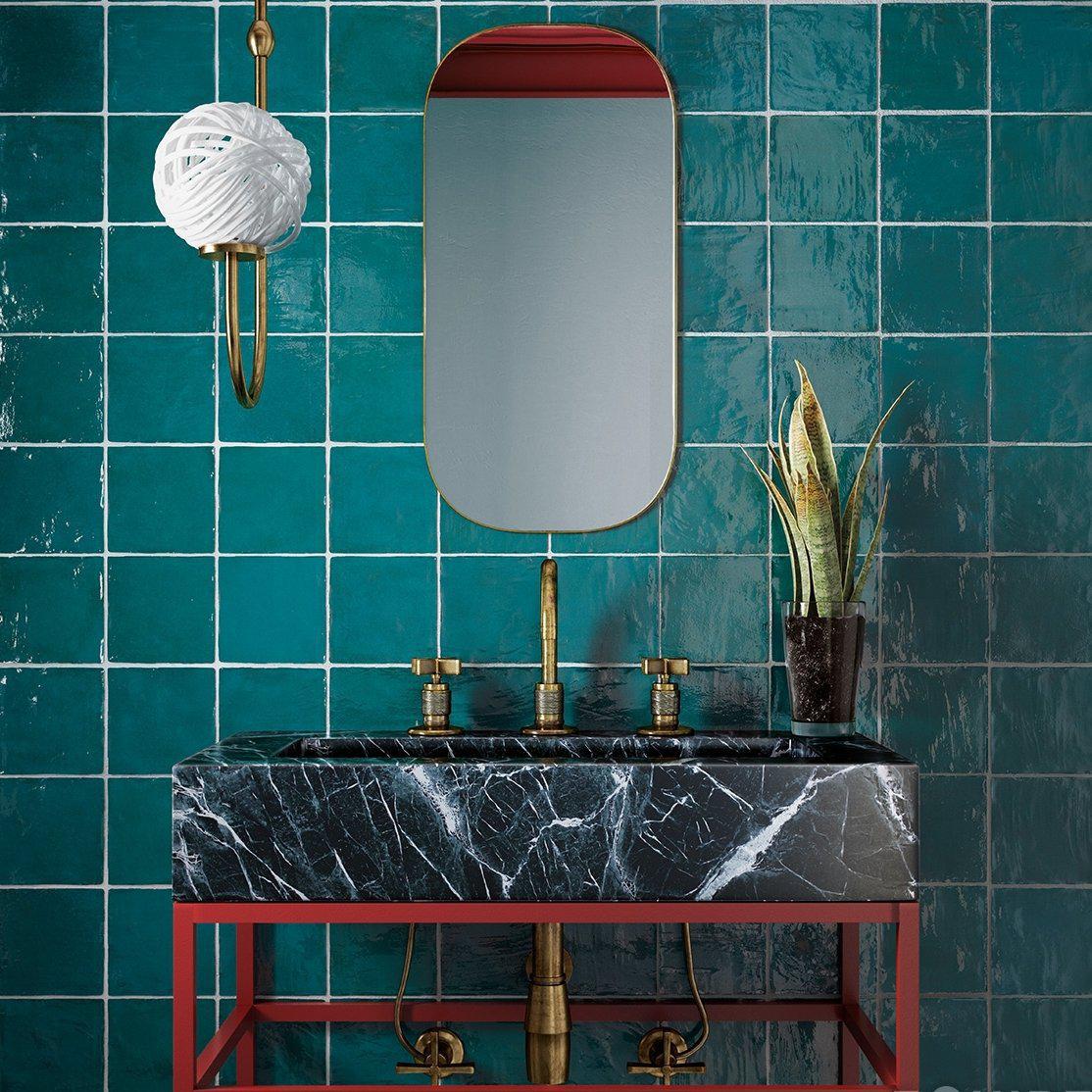 La Riviera Quetzal Ceramic Tile in Jewel Tone Green with a Modern Marble Farm Sink and Gold Bathroom Fixtures