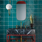 La Riviera Quetzal Ceramic Tile in Jewel Tone Green with a Modern Marble Farm Sink and Gold Bathroom Fixtures