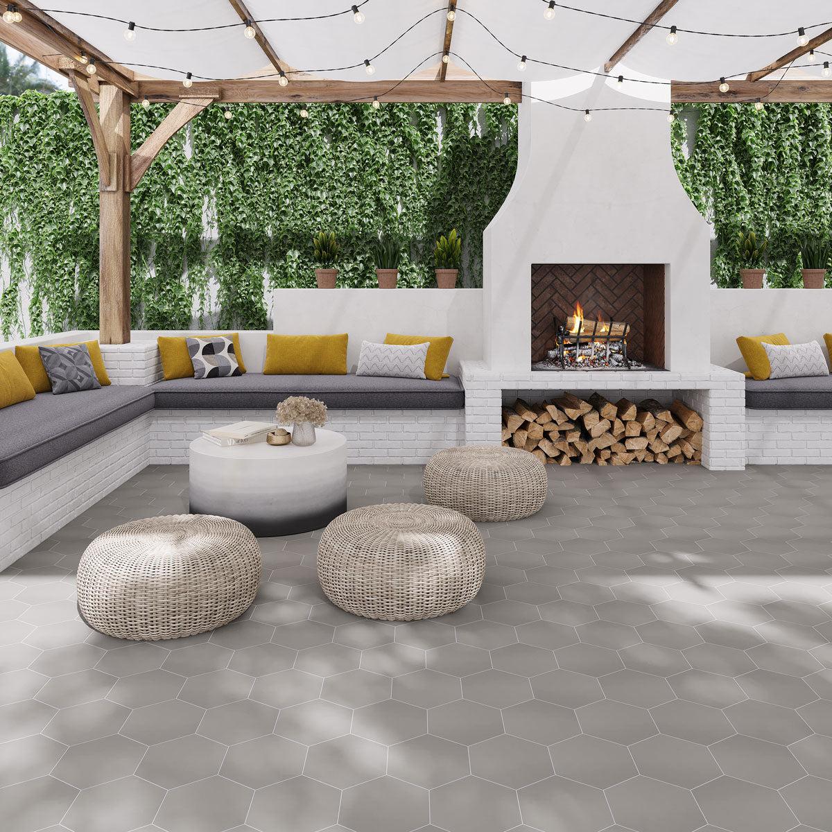 Outdoor seating area and fireplace with Magic Silver Porcelain Hexagon floor tiles