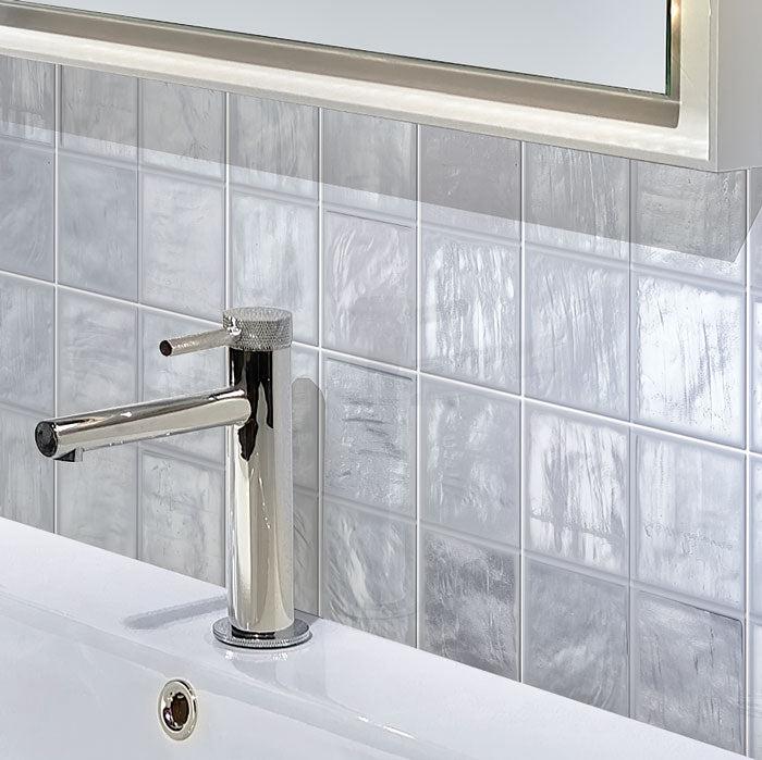 Brass Bathroom Tap on Mallorca Blue Ceramic Tile Background