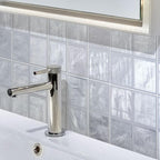 Brass Bathroom Tap on Mallorca Blue Ceramic Tile Background