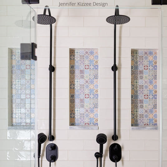 White ceramic subway tile shower with colorful Moroccan tile niche decor