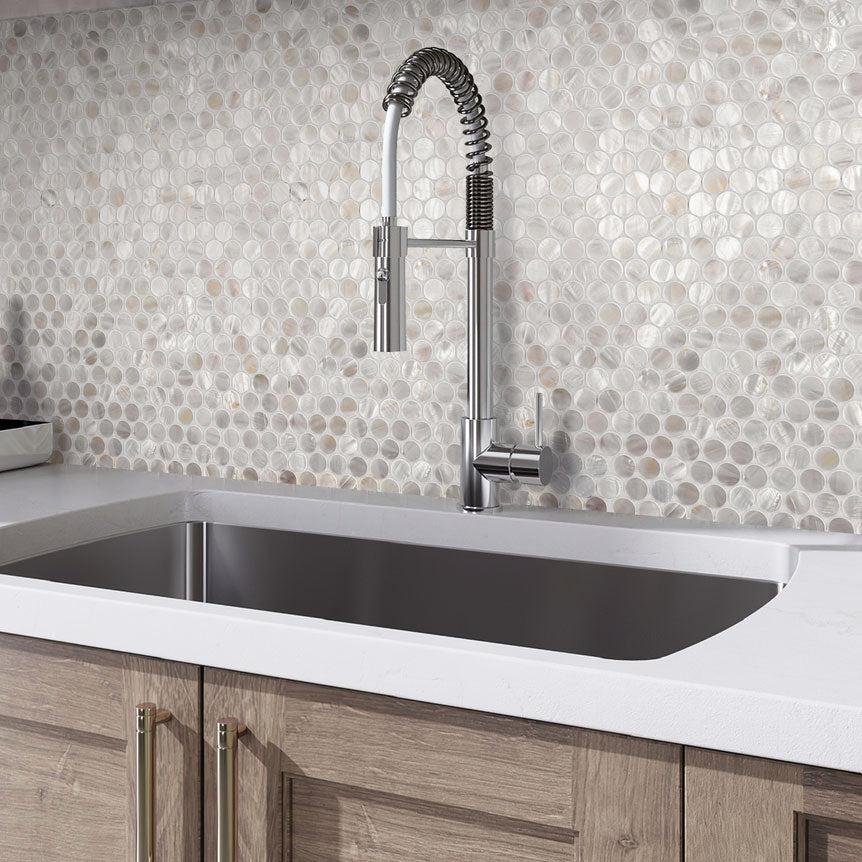 Mother of Pearl shell penny tile backsplash with natural wood cabinets