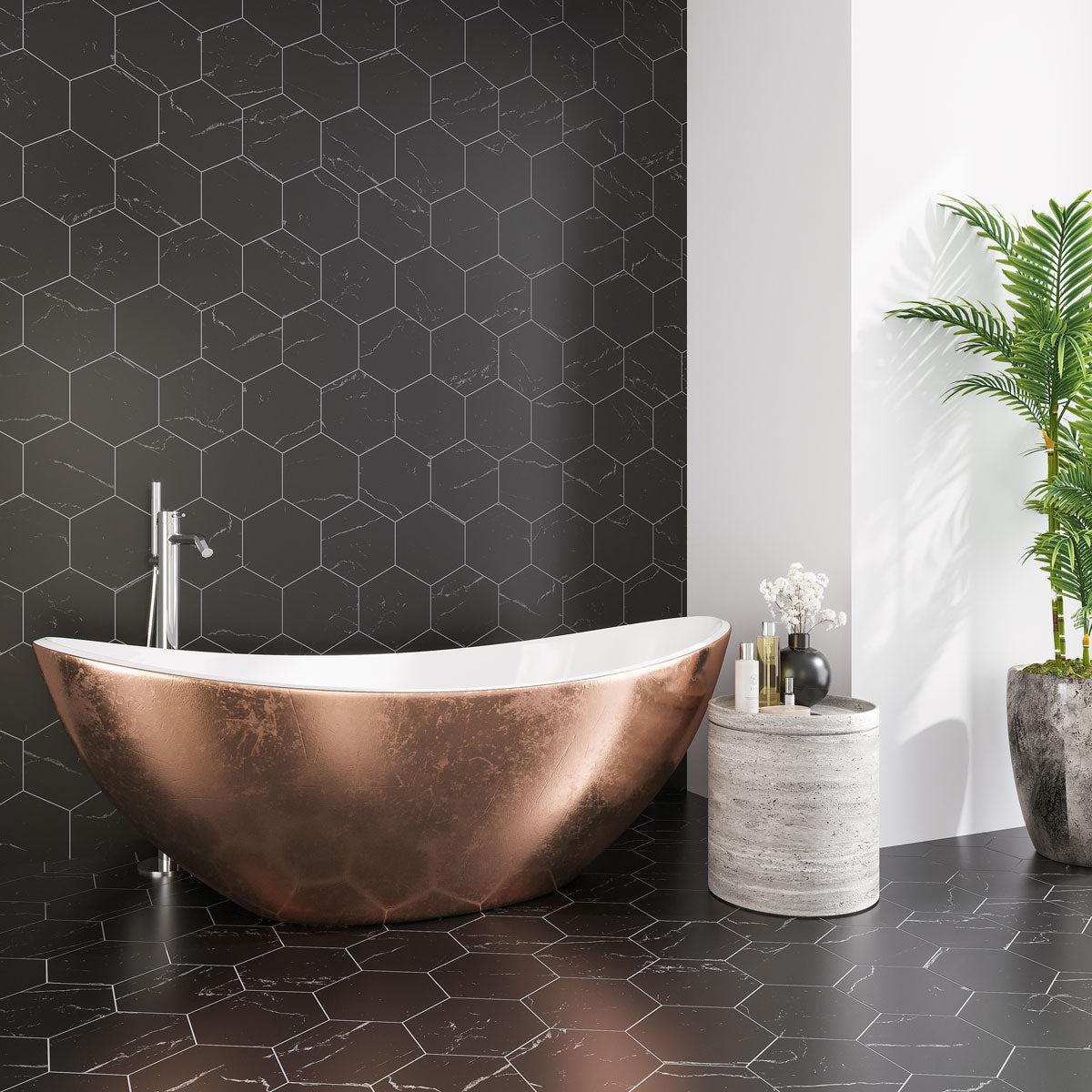 Black and white bathroom with Nero Marquina marble hexagon wall and floor tile with a copper soaking tub