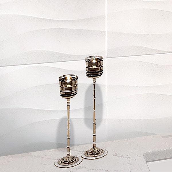 Modern Golden Candlesticks Stand In Front Of Neutral Blanco Five Wall