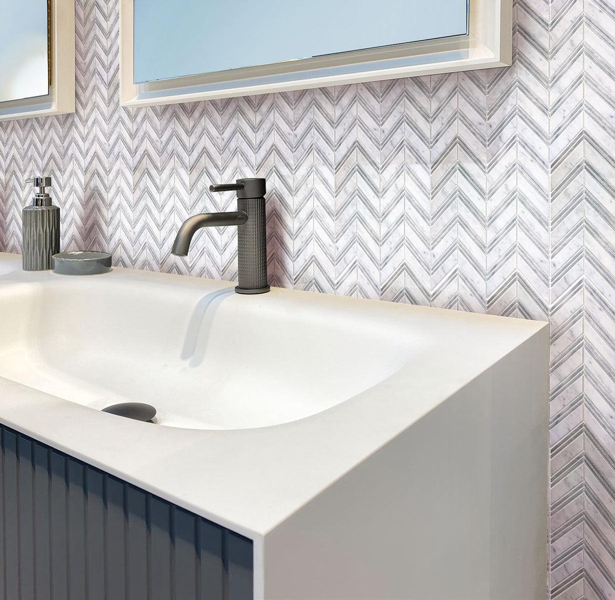 WHite & grey bathroom with Nova Chevron Carrara Marble Tile backsplash