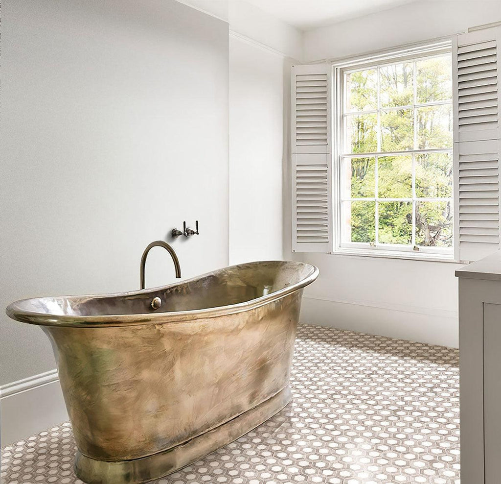 Nova Hex Wooden Beige Marble Tile floor in white bathroom with brass bath