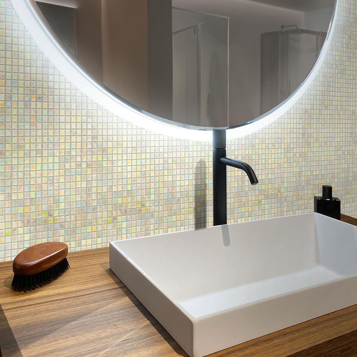 The bathroom glistens with Pearlescent Clear Squares Glass Tile accents