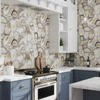 Blue and white kitchen with beige and gold agate slice patterned backsplash