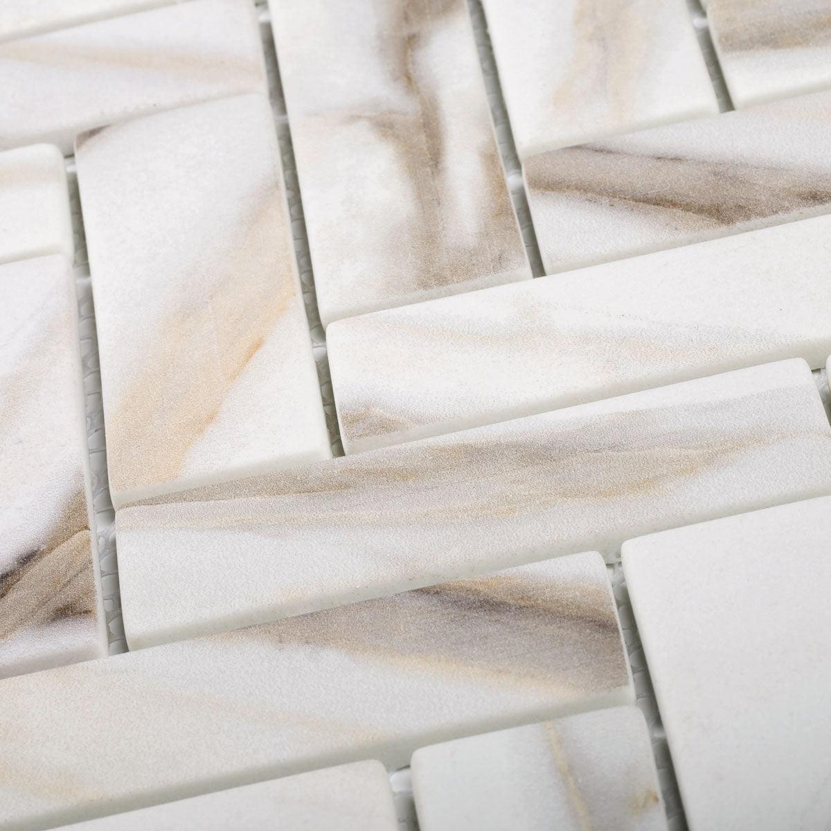 Close up of Recycled Glass Herringbone Mosaic In Calacatta Marble Color