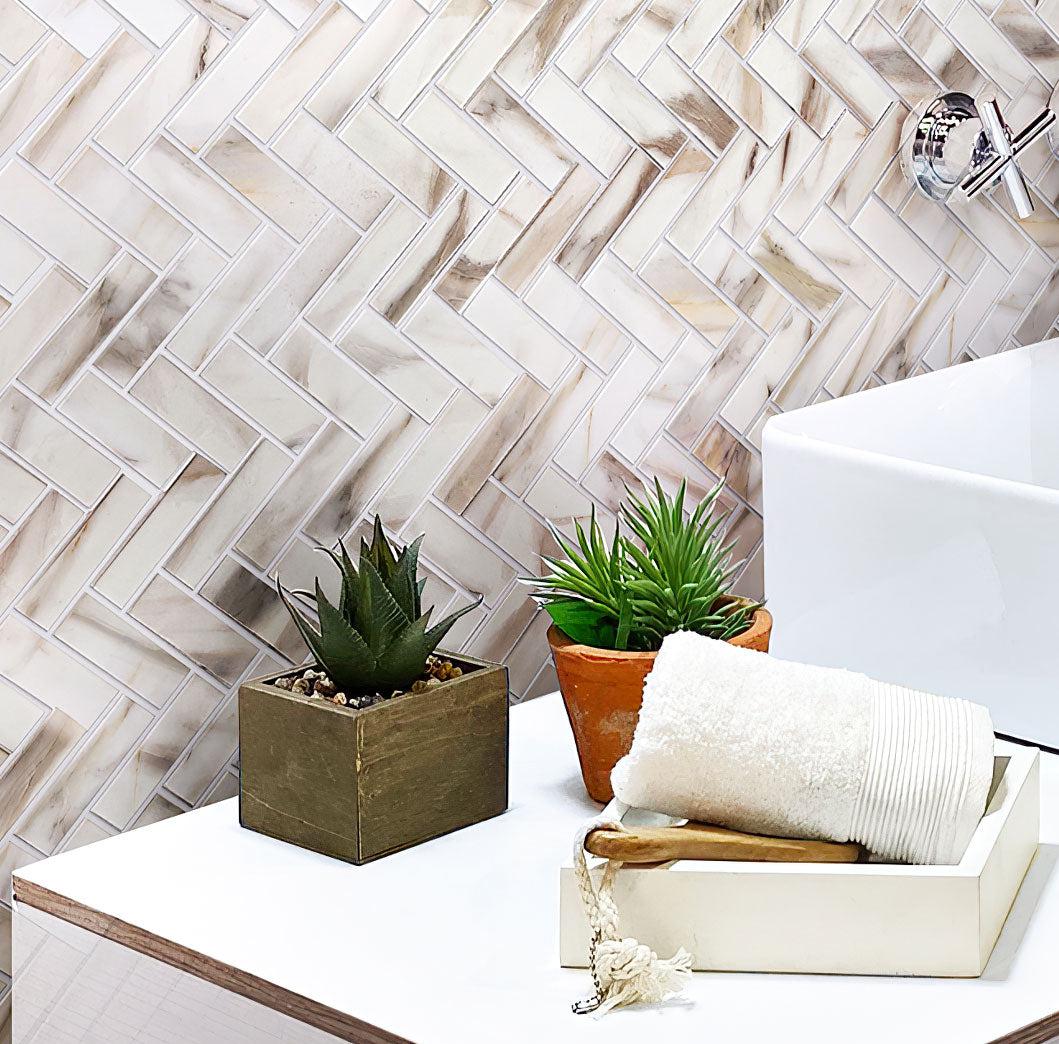 Recycled herringbone glass mosaic in calacatta marble bathroom wall