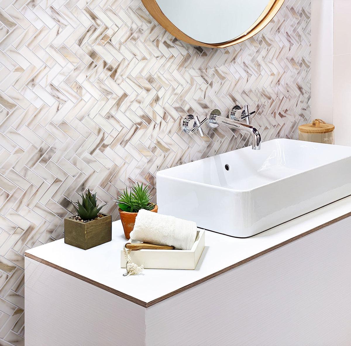 Joyful bathroom interior with recycled herringbone glass mosaic in calacatta marble color
