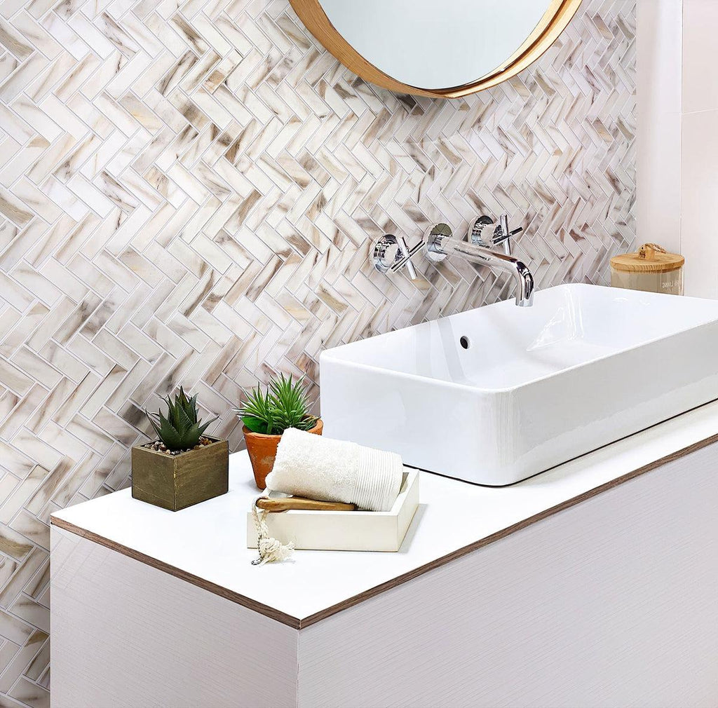 Joyful bathroom interior with recycled herringbone glass mosaic in calacatta marble color