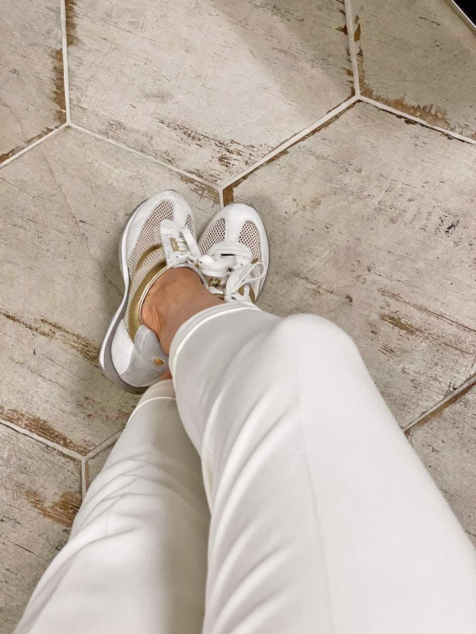 White farmhouse floor with an antiqued wood look with hexagon porcelain tiles