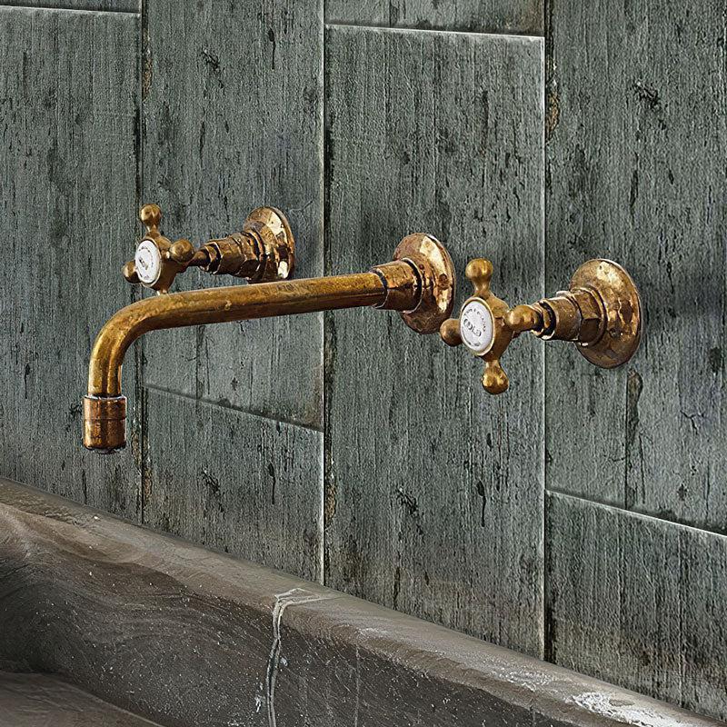 Old Bronze Bathroom Faucet on the Background of the Retro Cendra Wall