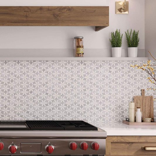 Gray and white flower pattern tiled kitchen wall behind the stove