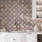 Patterned kitchen tile backsplash with white cabinets and gold hardware