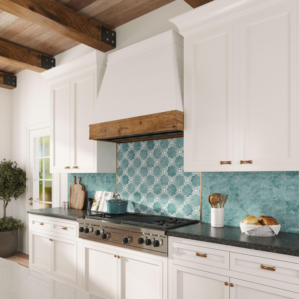 White kitchen cabinets with Santa Barbara Dappled Green Star and Decorative Cross backsplash