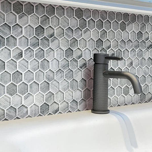 Washroom Water Tap on Background of Silver Wooden Glass Hexagon Mosaic Tile
