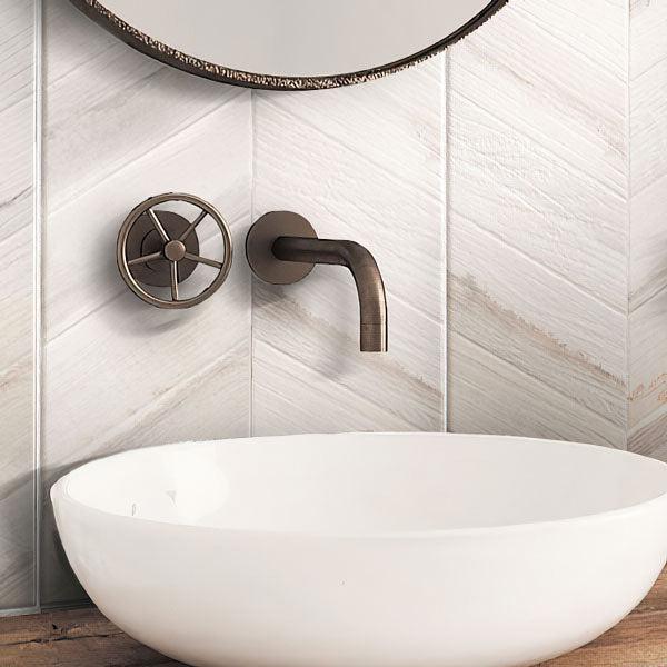 White Bathroom Sink on Background of Spiga Olson Blanco Wood-Look Chevron Porcelain Tile