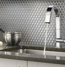 Metal penny round tile kitchen backsplash close-up