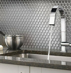 Metal penny round tile kitchen backsplash close-up