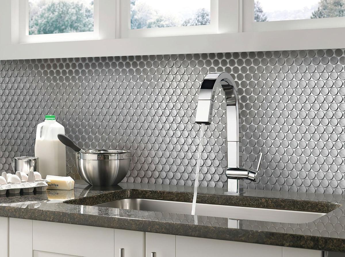 Shiny metal penny round tile kitchen backsplash