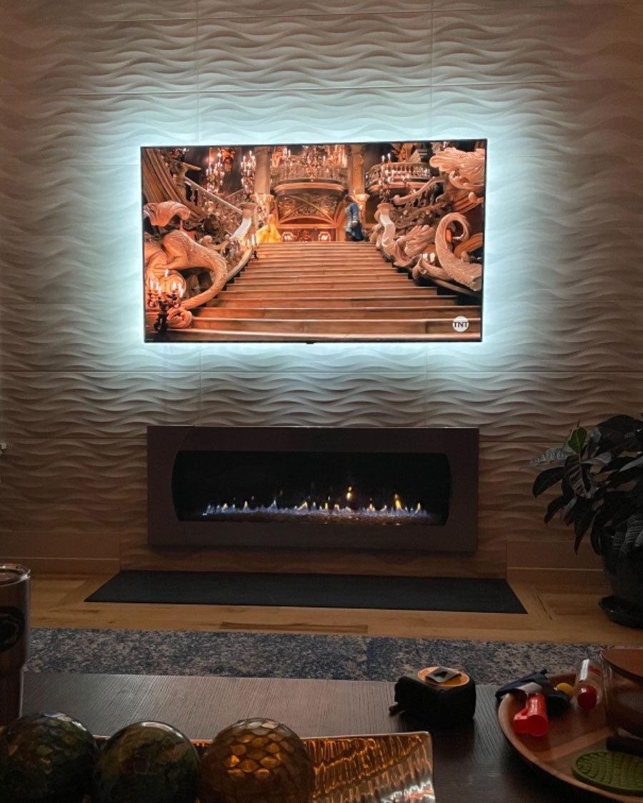 Tango Ivory Wave 3D Porcelain Tile accent wall with a gas fireplace