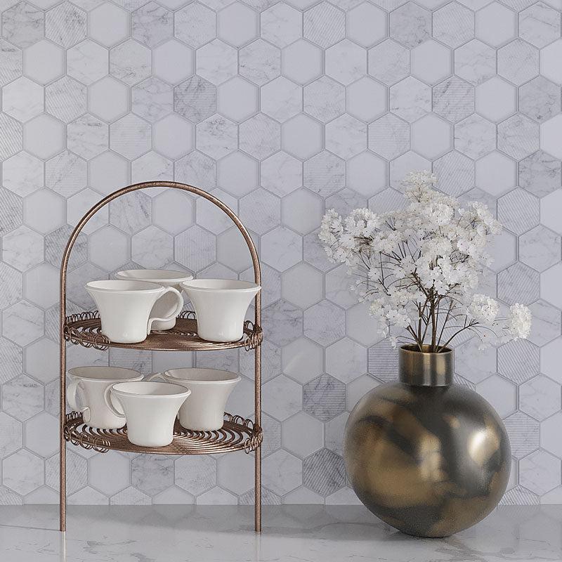 A Set of Tea Cups and a Brass Jug with Flowers against the Textured Carrara And Glass Hexagon Mosaic Wall