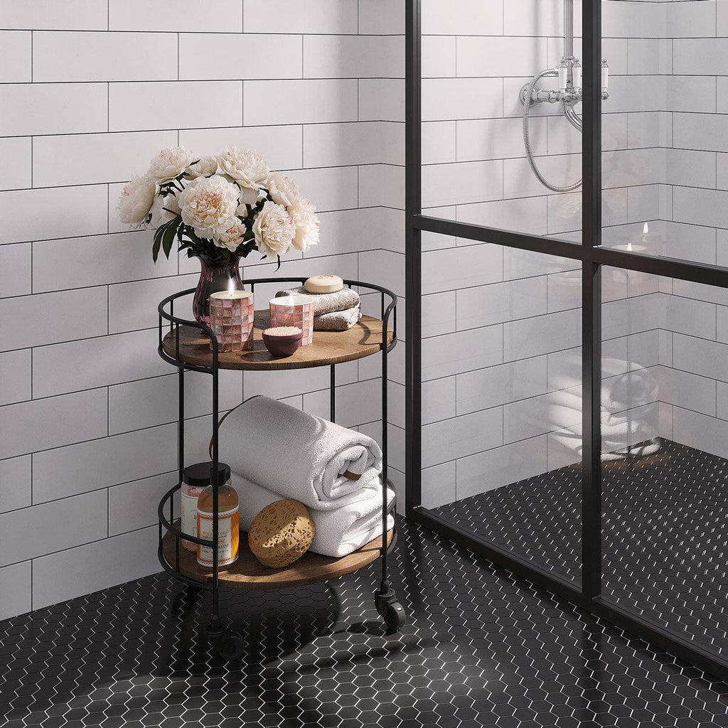 White marble subway tile bathroom wall with black hexagon floor tiles