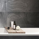 White Bathtub in Background of Varana Marengo Stone Look Black Porcelain Tile Wall