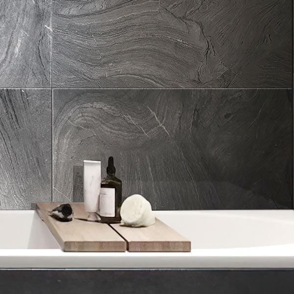 White Bathtub in Background of Varana Marengo Stone Look Black Porcelain Tile Wall