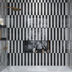 Black and white subway tile shower with a striped pattern