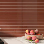Skinny cermaic subway tile backsplash in brick red