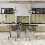 Olive green subway tile backsplash with a wood-look hexagon floor