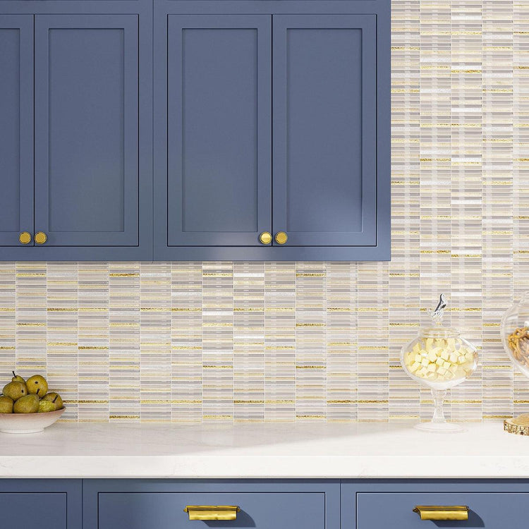 Blue kitchen cabinetry with white and gold glass tile backsplash