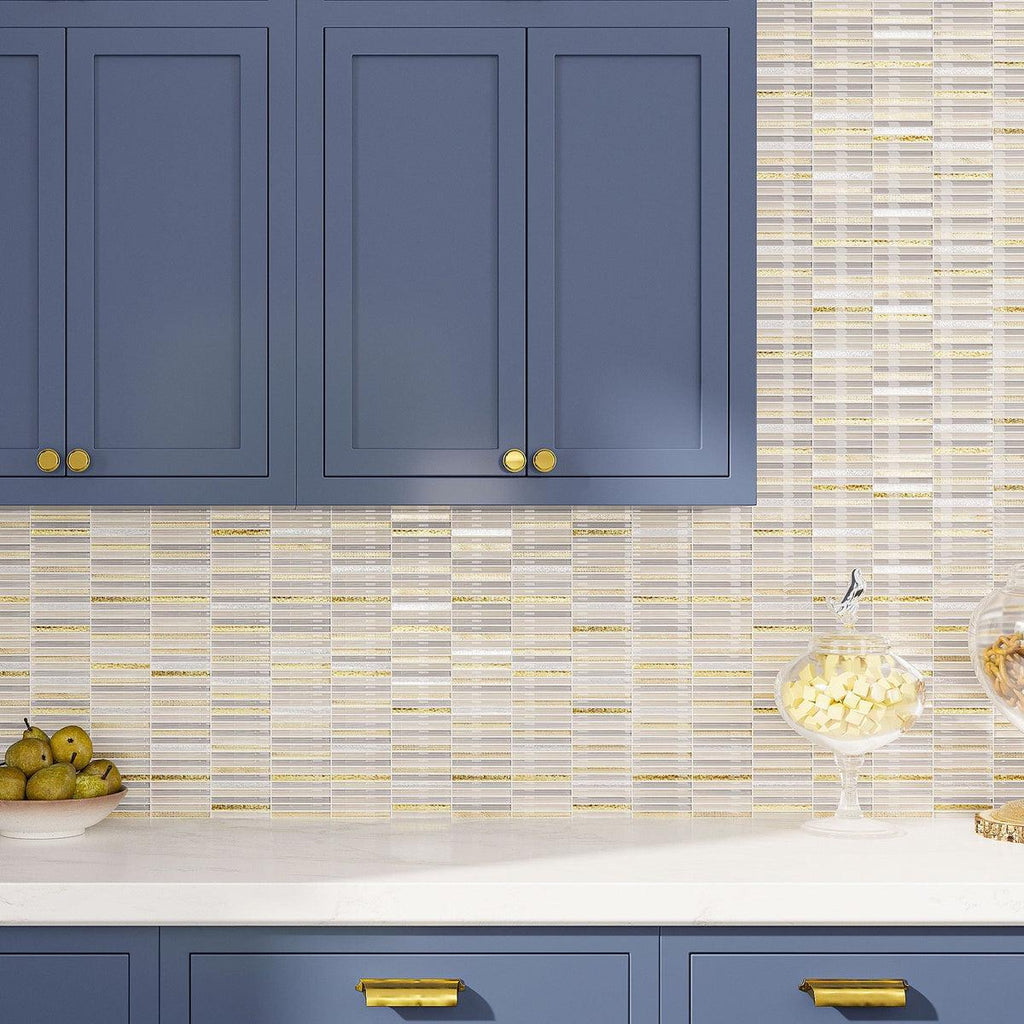 Blue kitchen cabinetry with white and gold glass tile backsplash