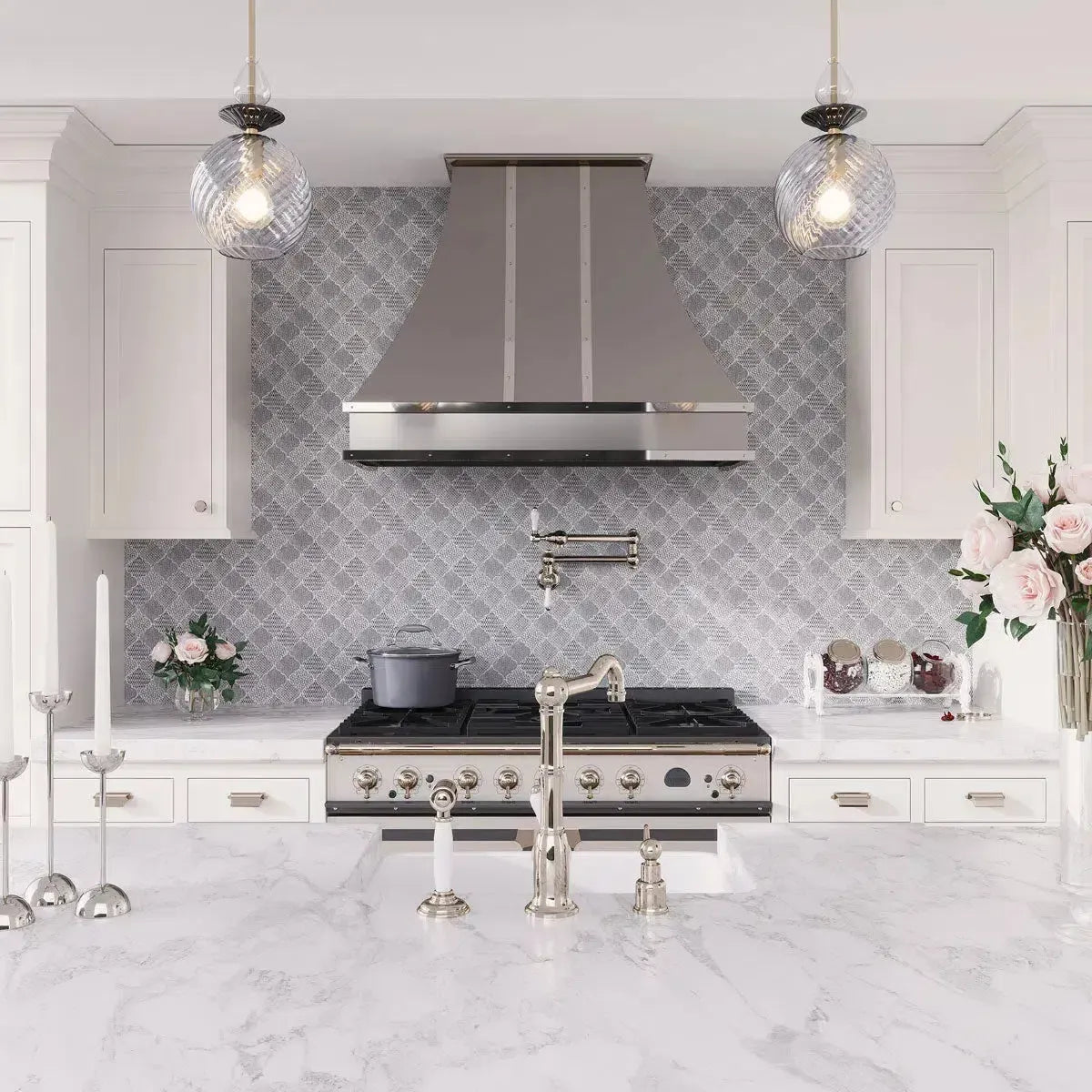 White and silver kitchen with etched marble arabesque backsplash tile and brushed nickel hood range