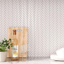 Glossy white peel & stick tile herringbone backsplash